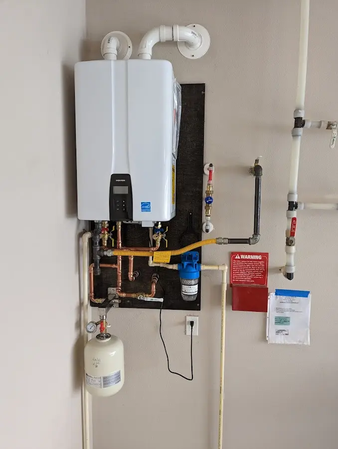 Professional plumber installing copper piping in a St. Louis Park home